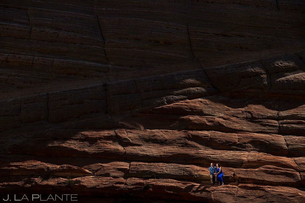 bride and groom to be on rock formations during Zion engagement
