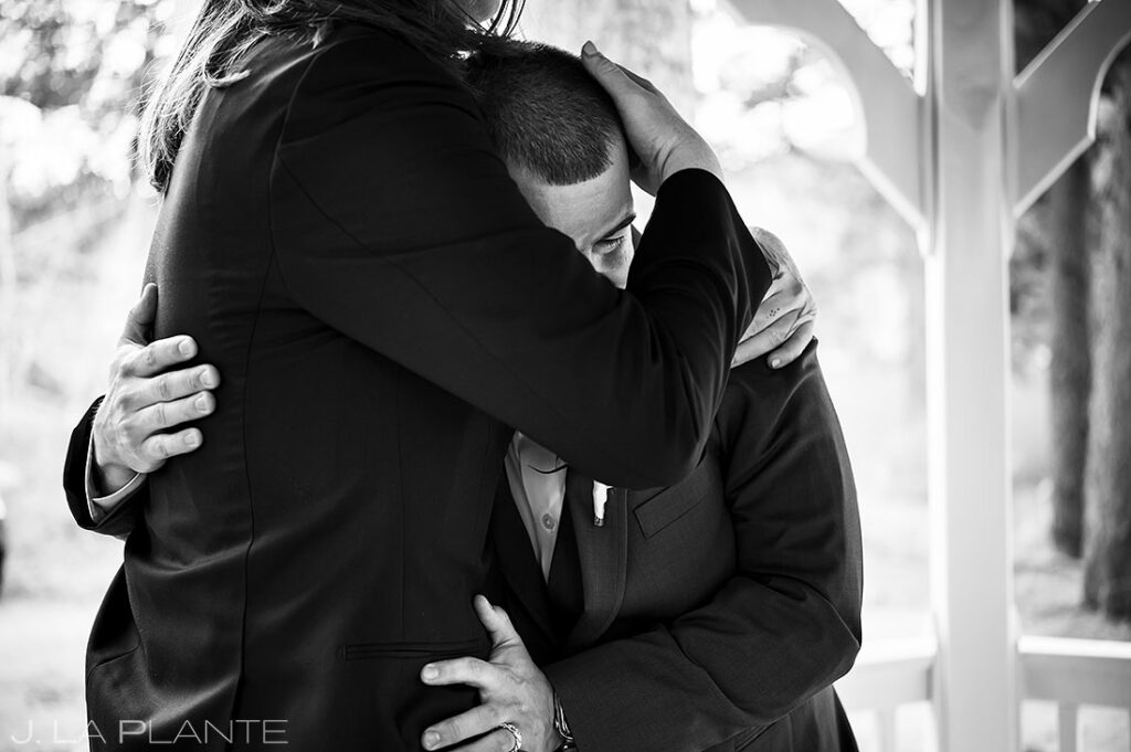 best man hugging the groom after wedding ceremony