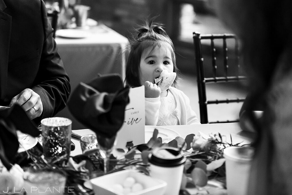 flower girl trying to stuff bread into her mouth