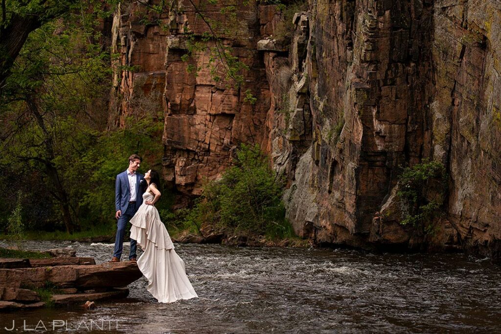 bride and groom to-be by mountain river