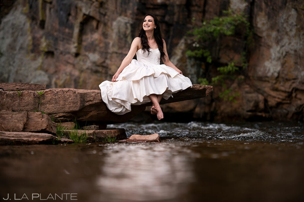 bride to-be posing by mountain river