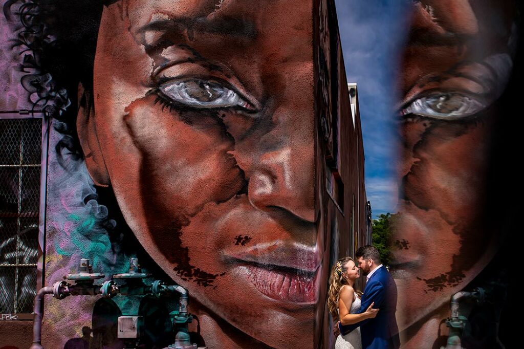 portrait of bride and groom with mural at Blanc Denver wedding