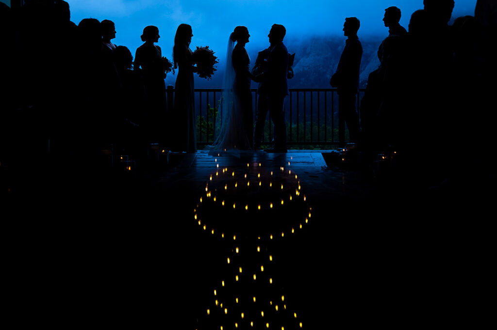 bride and groom silhouettes at mountain wedding ceremony