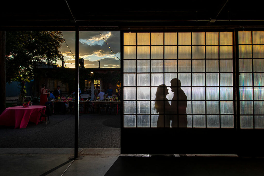 sunset portrait of bride and groom outside wedding venue