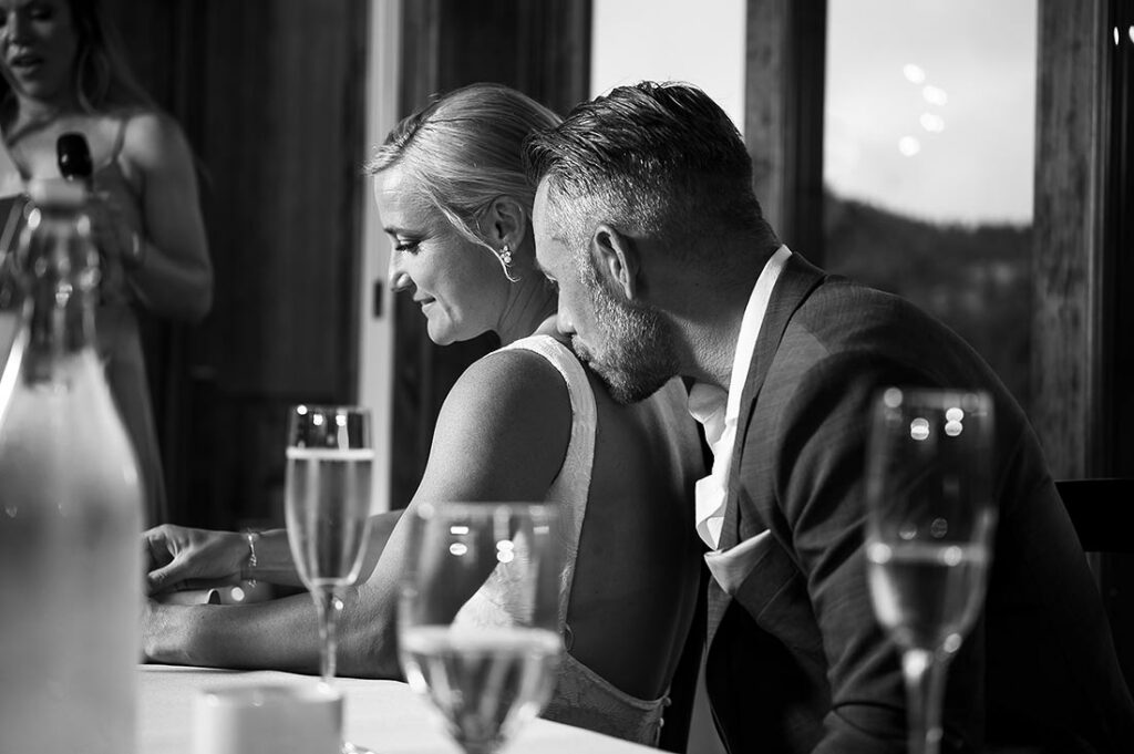 groom kissing bride during toasts at The Boulders Black Canyon Inn wedding