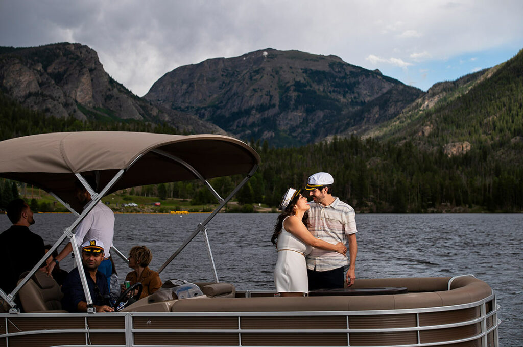 bride and groom on pontoon boat at Grand Lake Lodge wedding