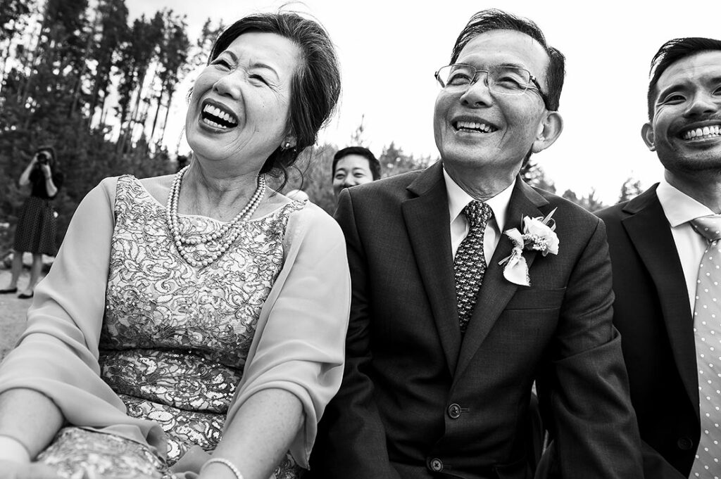 parents of the bride smiling during ceremony