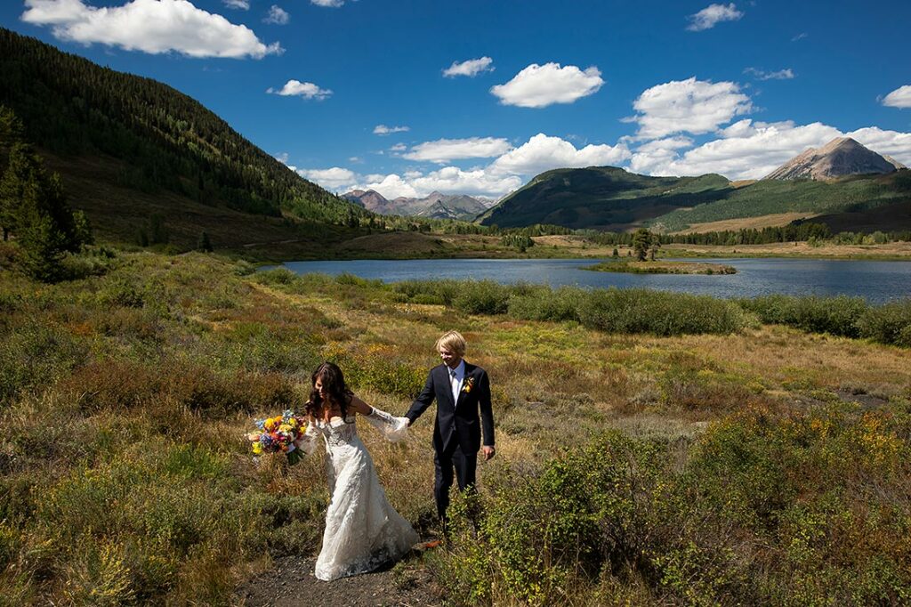 portrait of bride and groom hiking in mountains at Crested Butte wedding
