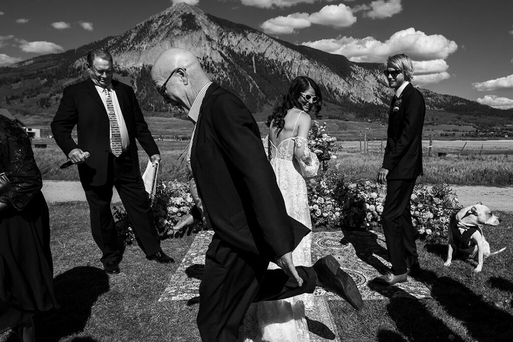 father of the bride tripping over her dress during ceremony