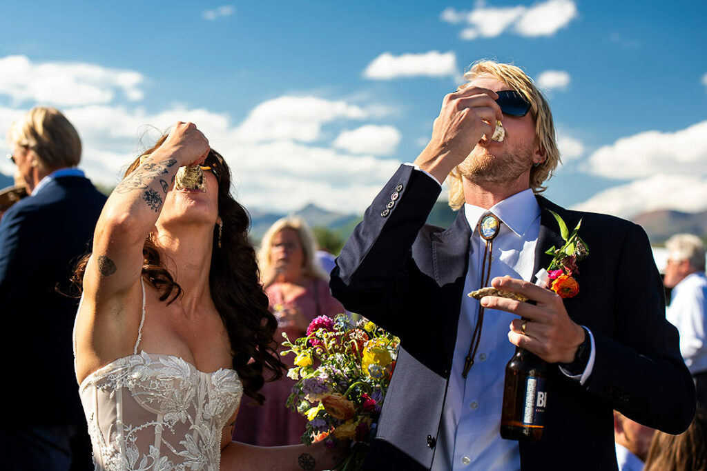 bride and groom eating oysters at Crested Butte wedding