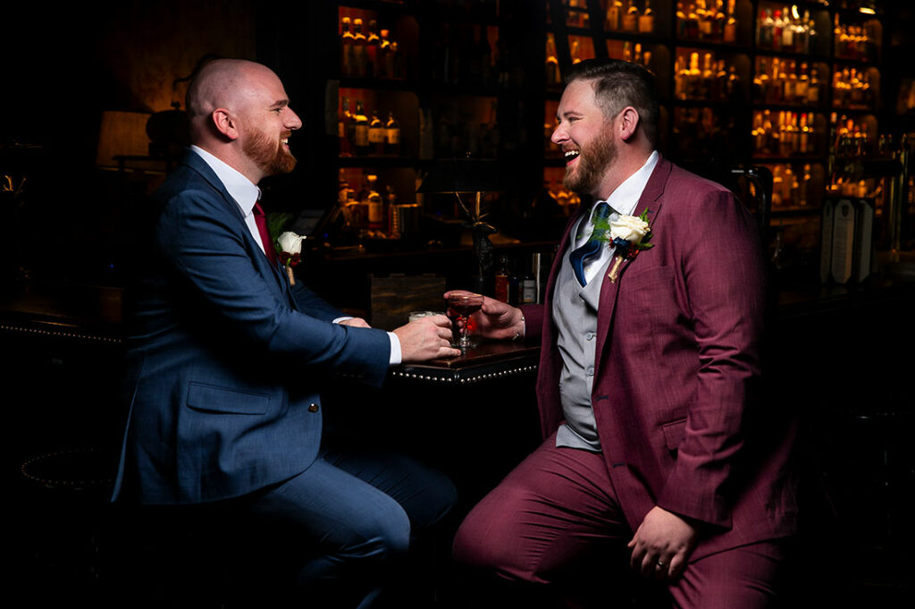 portrait of groom and groom at cocktail bar