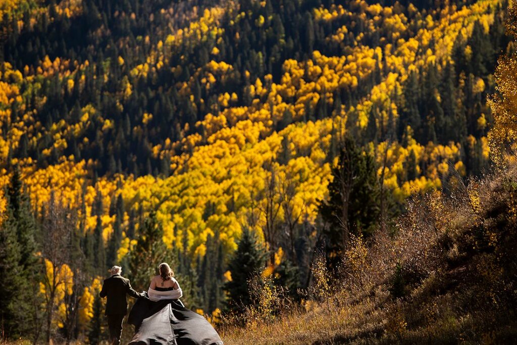 bride and groom walking in the mountains