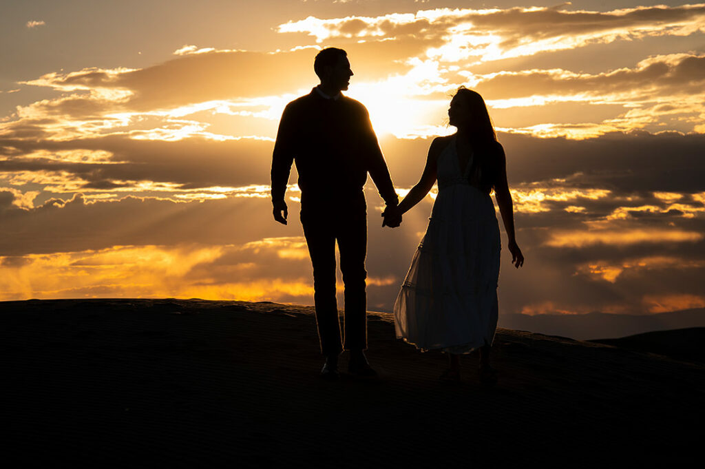 sunset portrait of bride and groom to-be at astrophotography engagement session