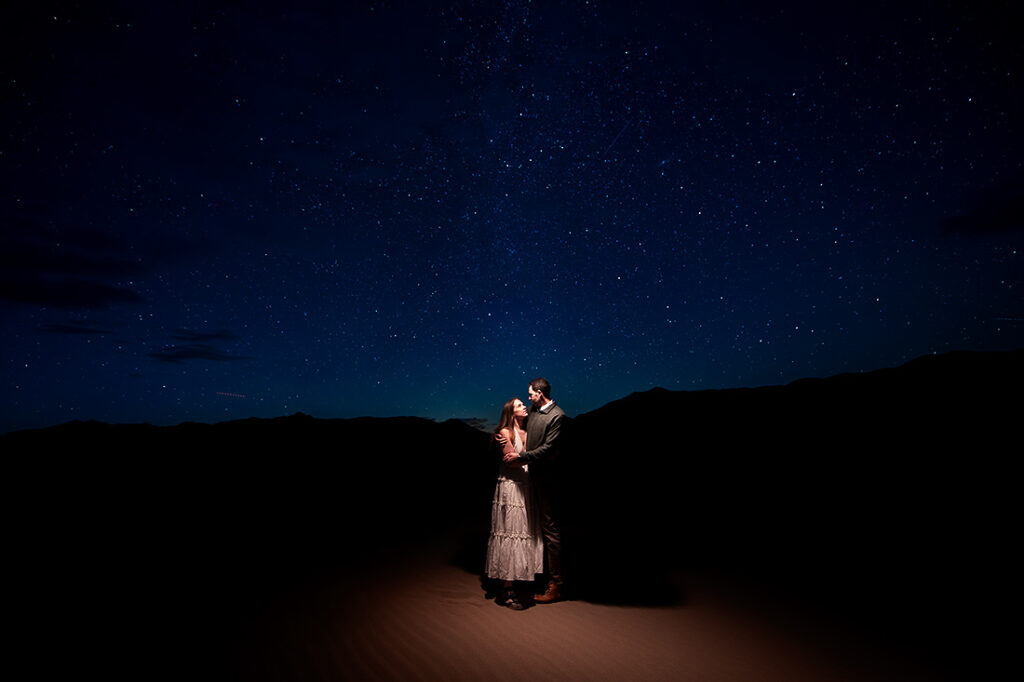 bride and groom-to-be under the stars at astrophotography engagement session
