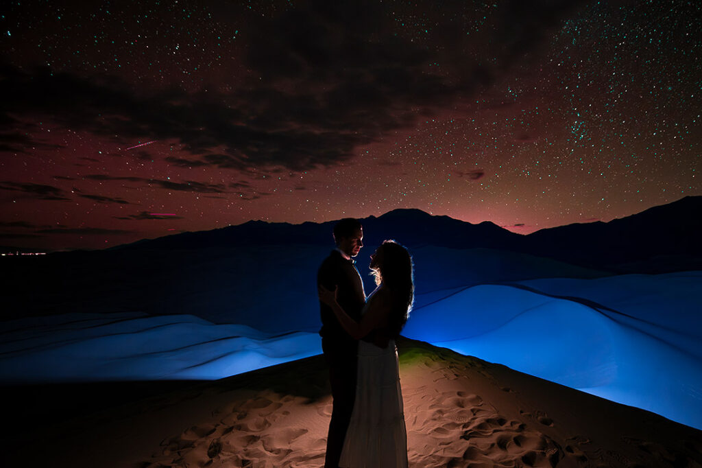 silhouette photo of bride and groom-to-be during astrophotography engagement session