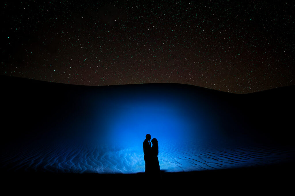 silhouette photo of bride and groom-to-be during astrophotography engagement session
