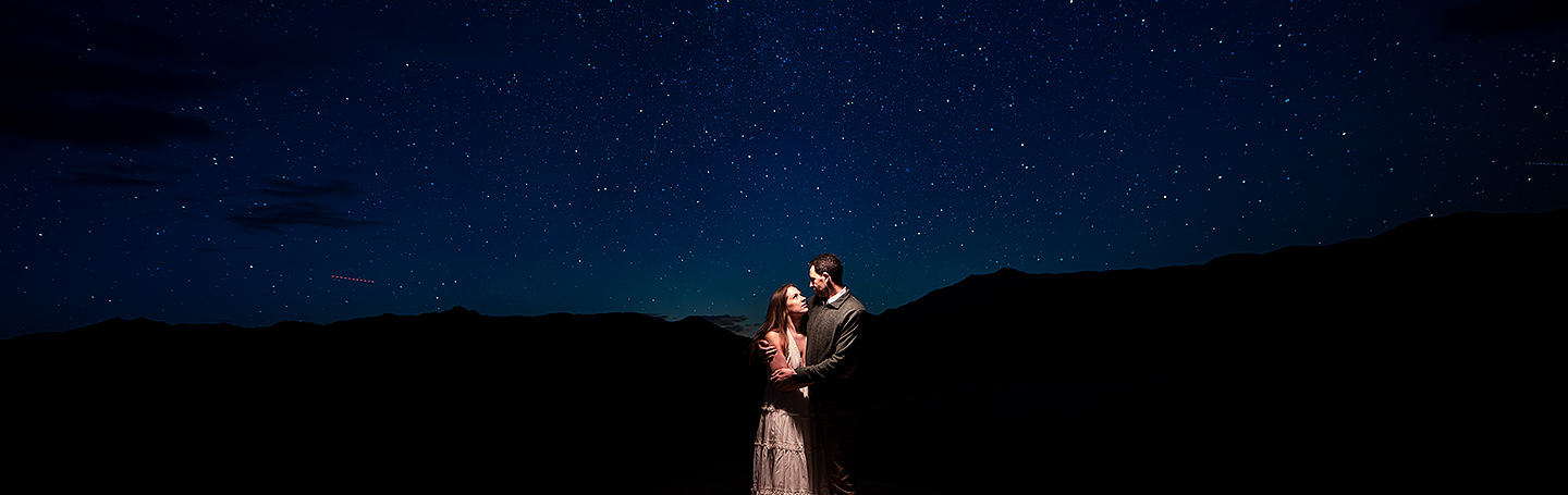 bride and groom-to-be under the stars at astrophotography engagement session