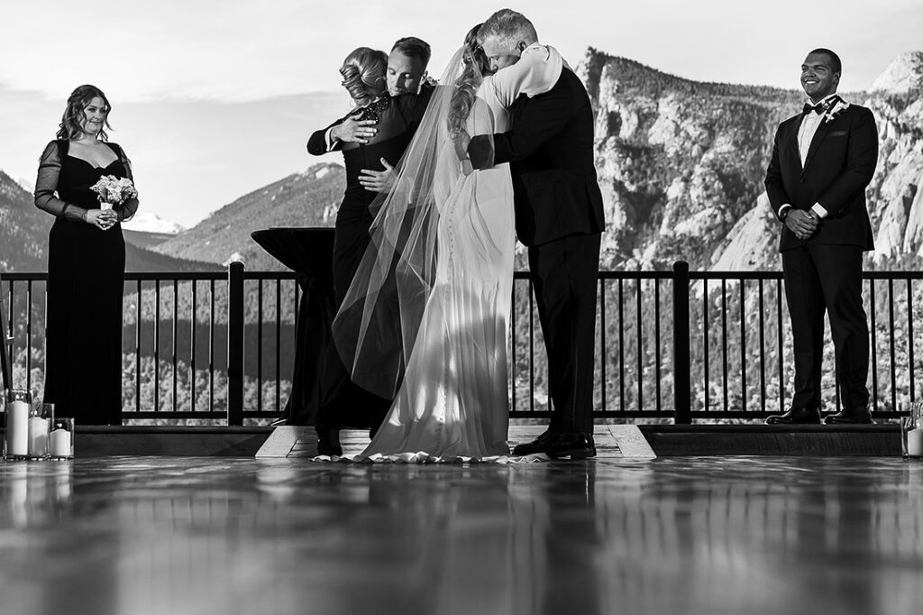 bride and groom hugging parents at winter wedding at The Boulders