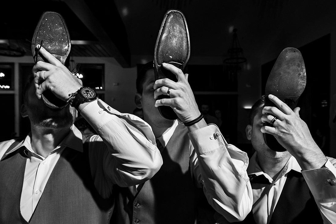 best wedding photos of 2023 groomsmen drinking out of shoes