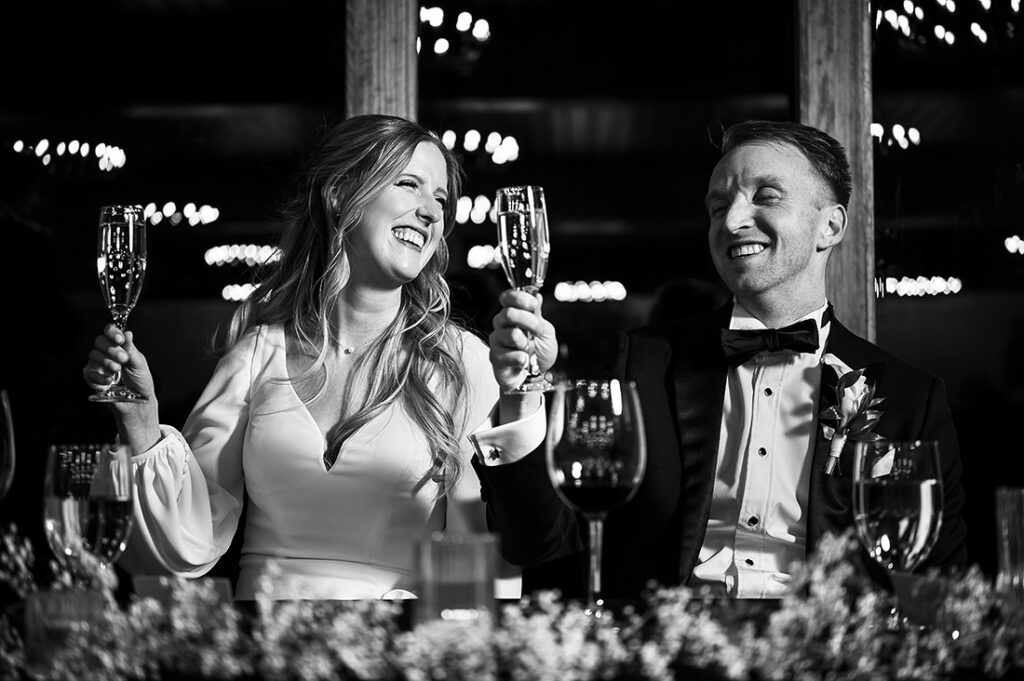 bride and groom toasting each other at wedding reception