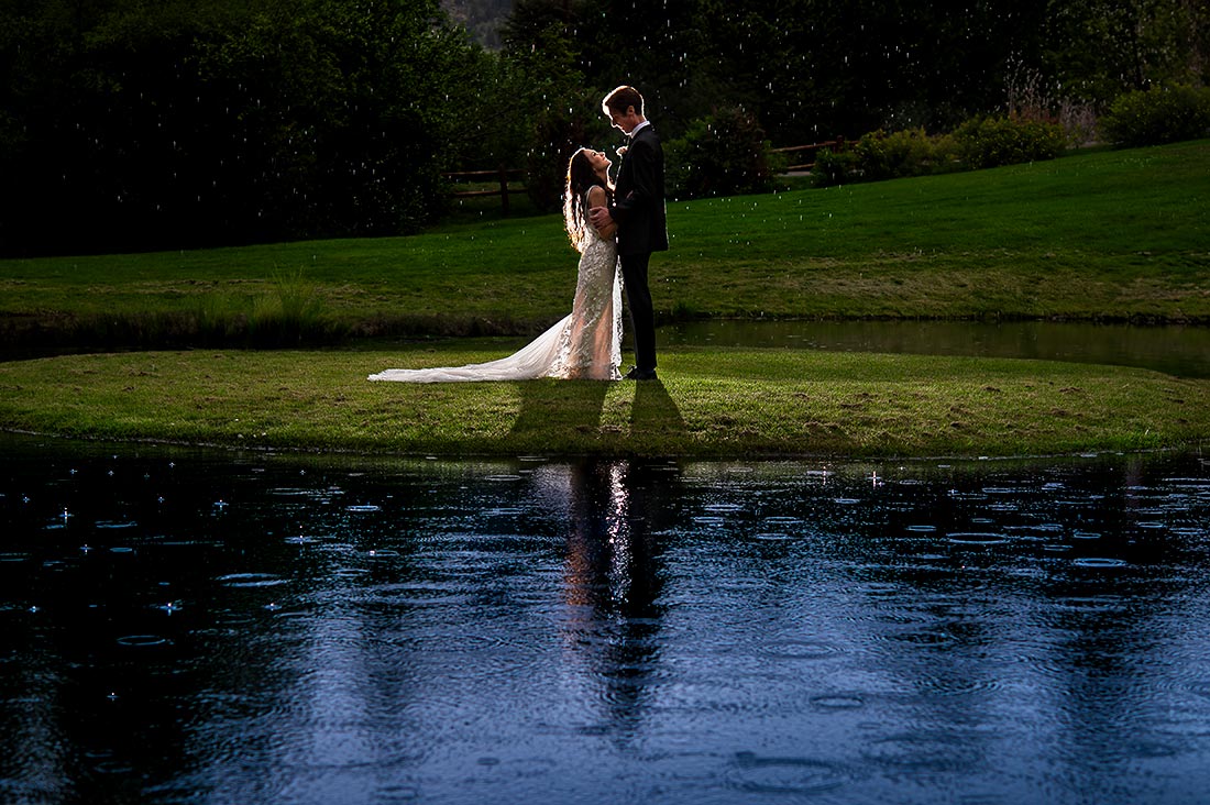 bride and groom outside in the rain
