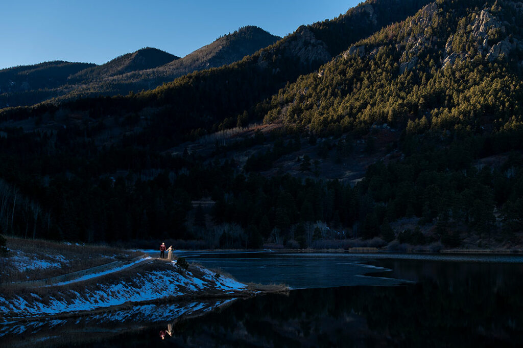 bride and groom to be by mountain lake during Pueblo engagement session
