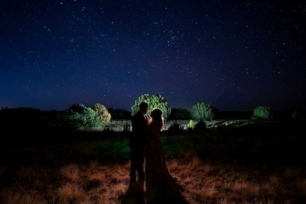 bride and groom kissing under the stars
