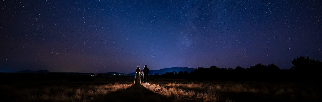 bride and groom beneath the Milky Way