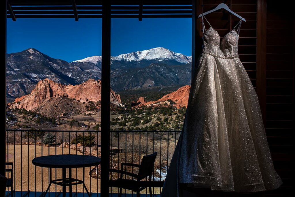 vibrant wedding photography wedding dress hanging in window
