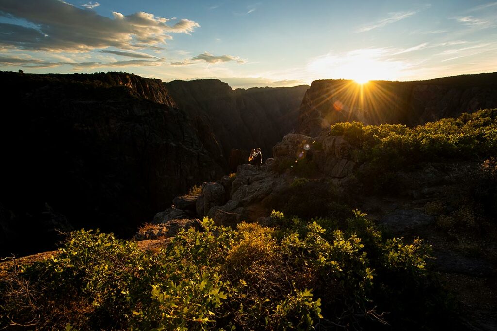 bride and groom-to-be kissing during sunset at Black Canyon of the Gunnison engagement session