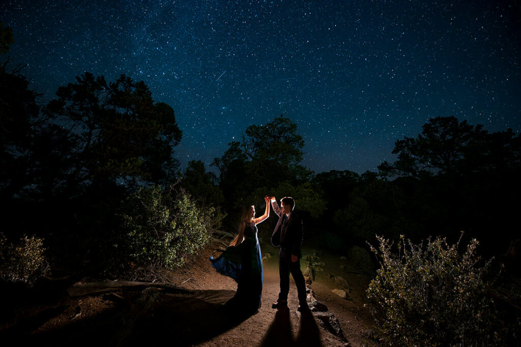 bride and groom-to-be dancing under the stars