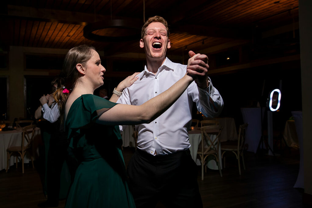 groomsman teaching bridesmaid how to dance