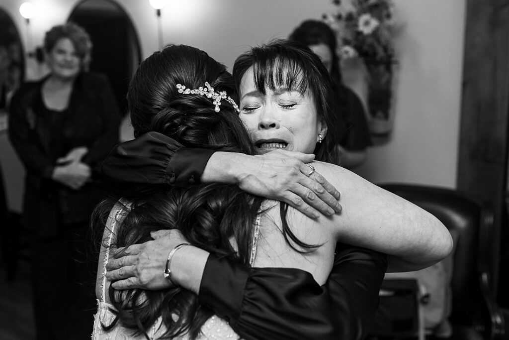Taharaa Mountain Lodge wedding bride hugging her mother