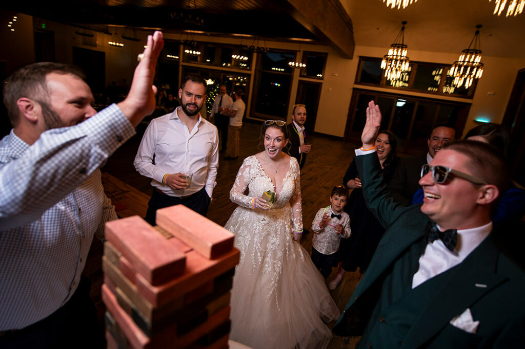 bride and groom playing giant Jenga during wedding reception