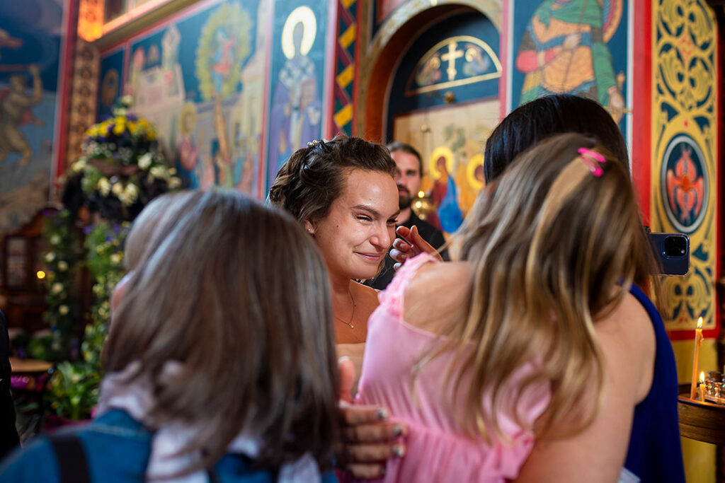 bride hugging guests after orthodox wedding ceremony in Colorado Springs