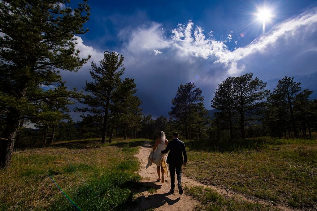 bride and groom hiking in the woods
