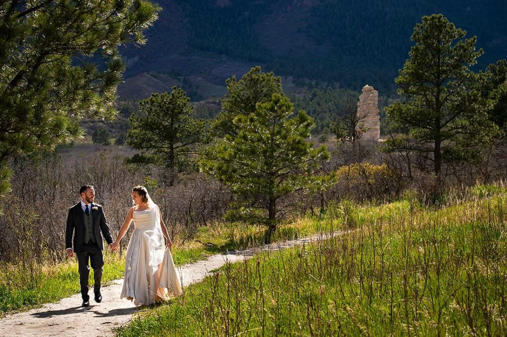 bride and groom walking in the Colorado mountains