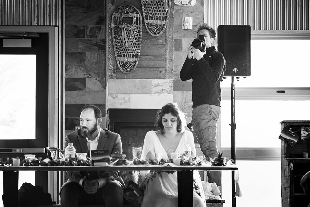wedding photographer taking photos of wedding toasts