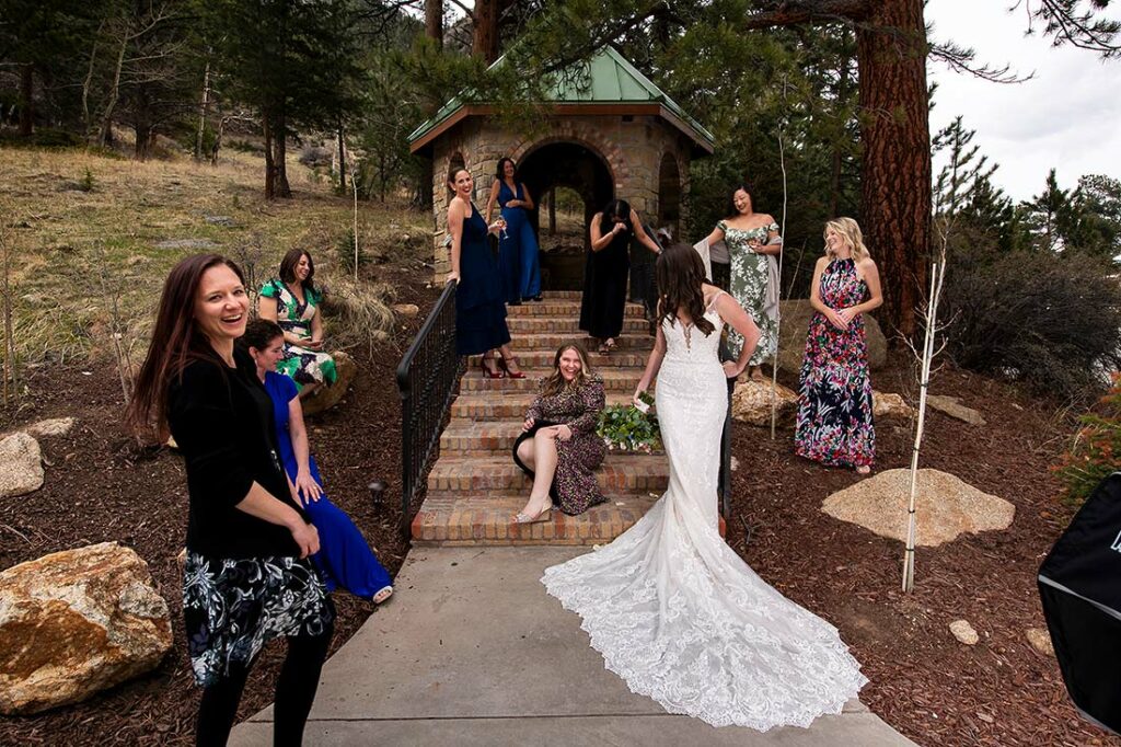 wedding photographer posing bridesmaids during Estes Park wedding at Della Terra