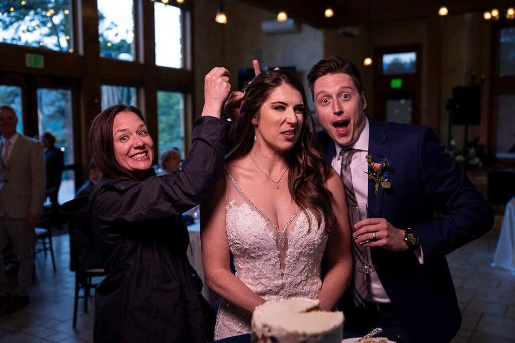 wedding photographer helping bride fix her hair during wedding reception