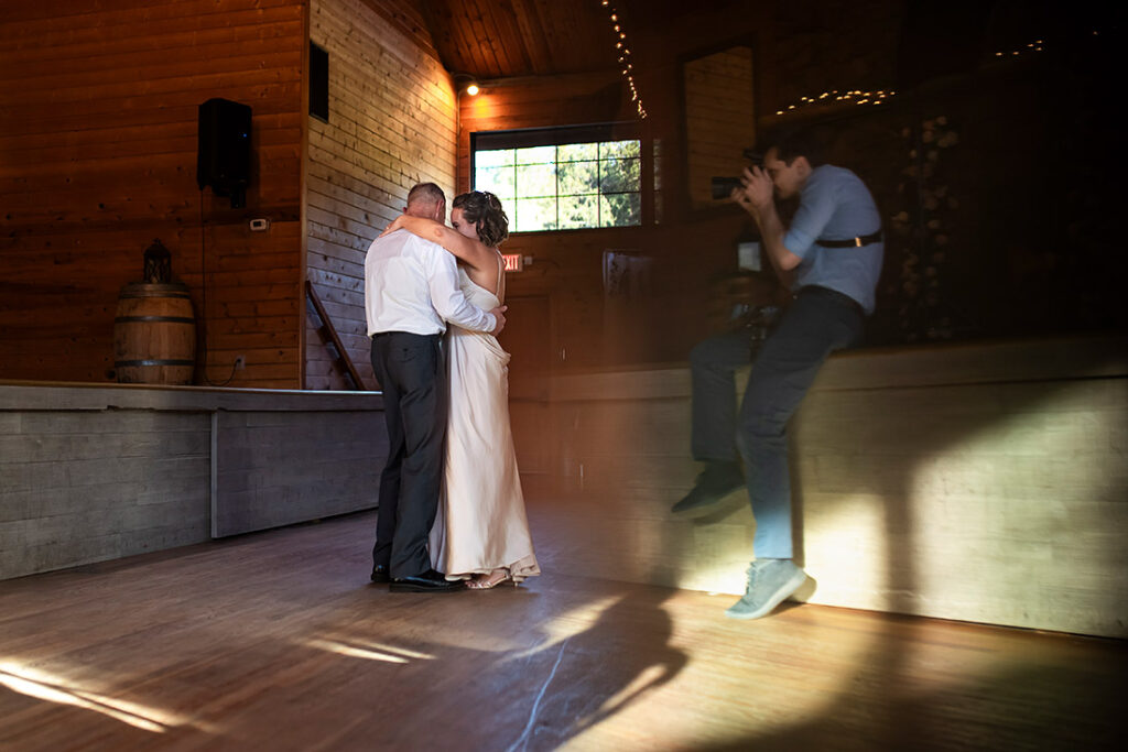 wedding photographer taking photos of the first dance during Pinecrest Wedding in Colorado Springs